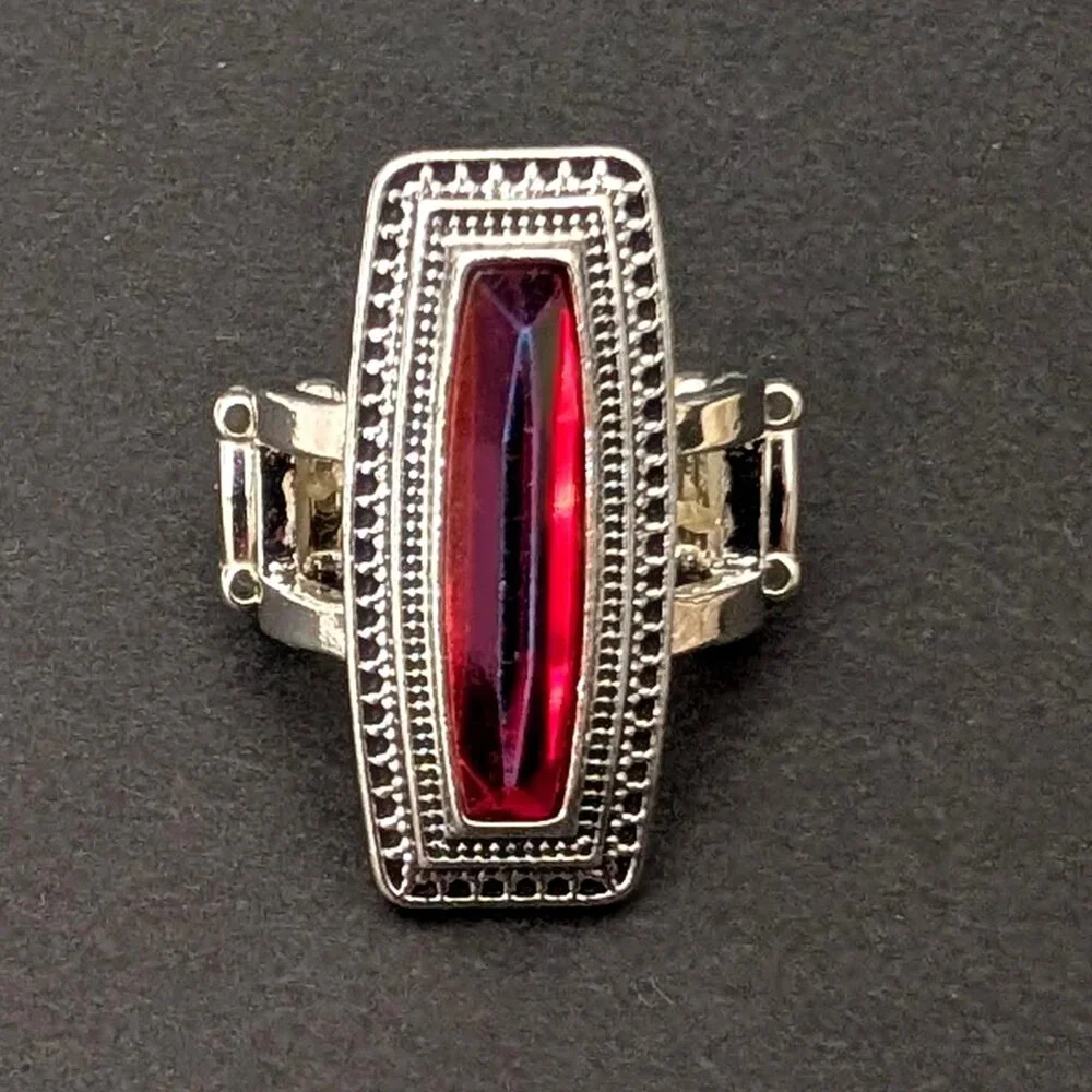 Orangey red glass ring with center bright blue stripe stretch ring